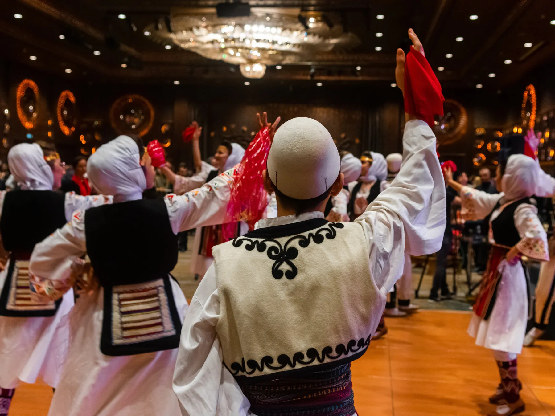 Albanian folk dancers performing in a circle at a community celebration